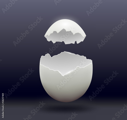 egg split in half on a dark background