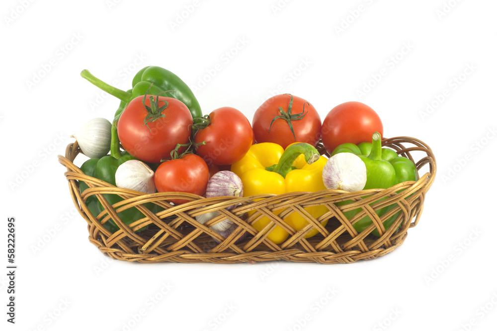 Assorted ripe vegetables in wicker basket isolated closeup Assorted ripe vegetables in wicker basket isolated closeup