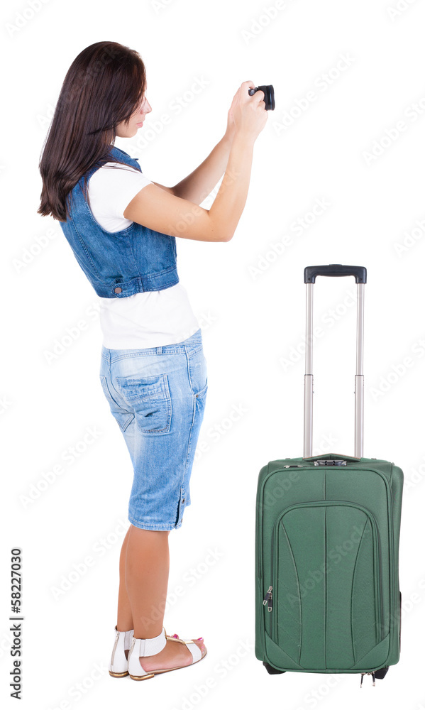 Back view of woman photographing traveling with suitcas. Back view of woman photographing traveling with suitcas.