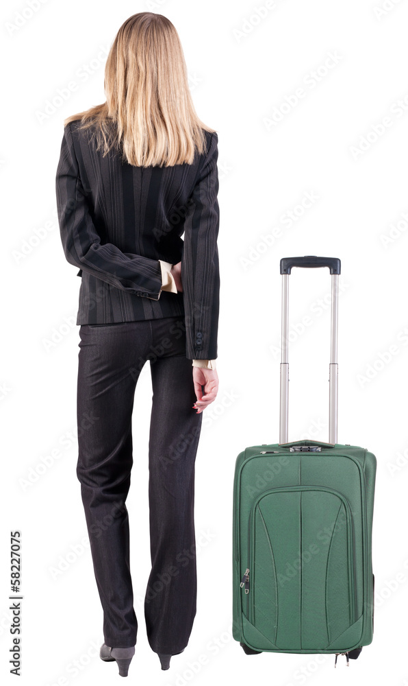 back view of thoughtful business woman traveling with suitcas. back view of thoughtful business woman traveling with suitcas.