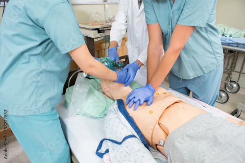 Obraz na płótnie Nurses And Doctor Performing CPR On Dummy