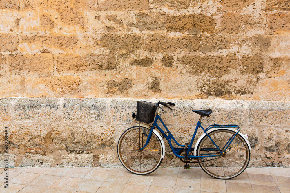 Bicycle in historical Ciutadella stone wall at Balearics