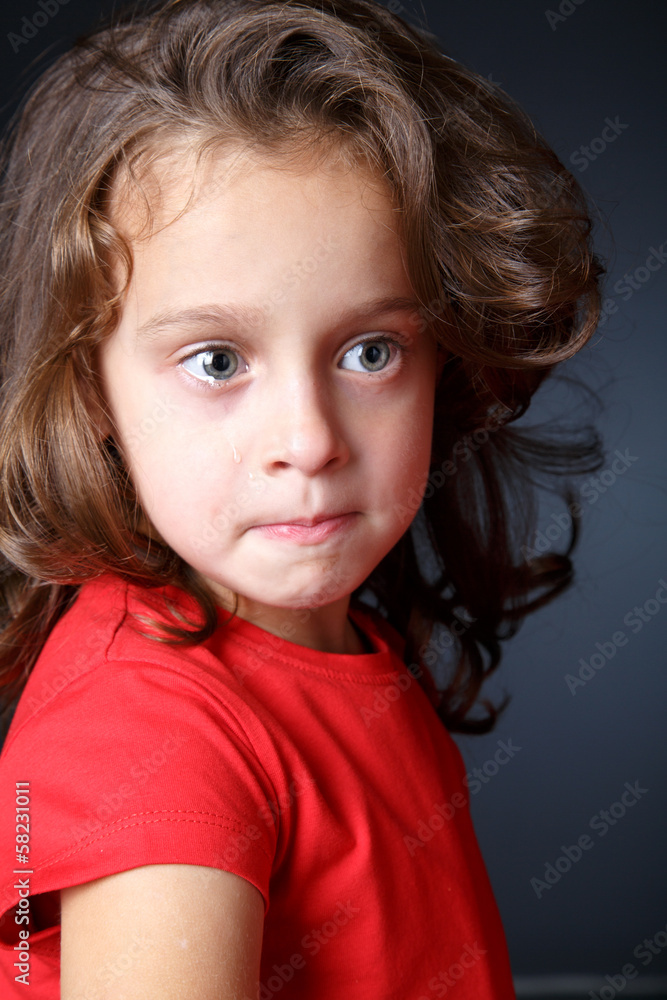 Portrait of crying girl in red Portrait of crying girl in red