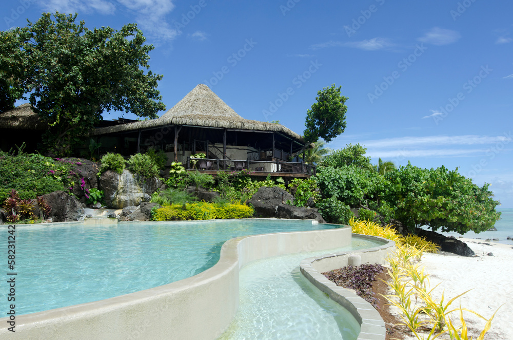Beach bungalow and a pool in tropical pacific ocean Island.