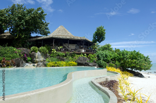 Beach bungalow and a pool in tropical pacific ocean Island. © Rafael Ben-Ari