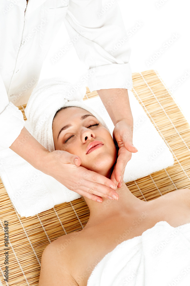 Fototapeta premium Woman in spa gets a facial massage