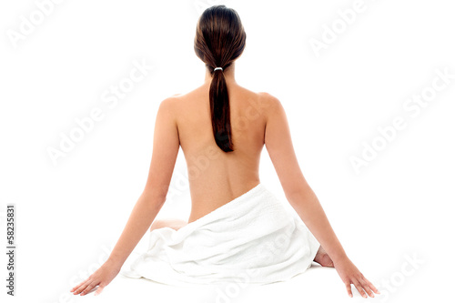 Naked woman with long hair, back pose.