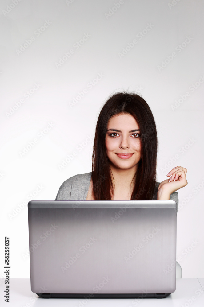 Happy young casual woman sitting at the table Happy young casual woman sitting at the table