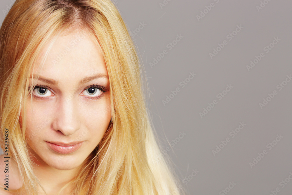closeup portrait of a young blonde girl on gray background closeup portrait of a young blonde girl on gray background