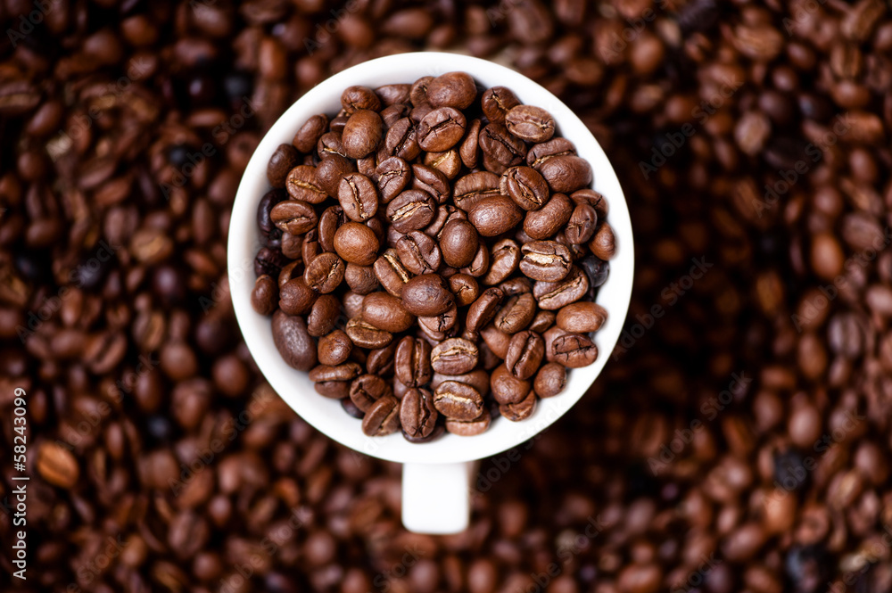 African fresh bio coffee beans with cup, detail view from top African fresh bio coffee beans with cup, detail view from top