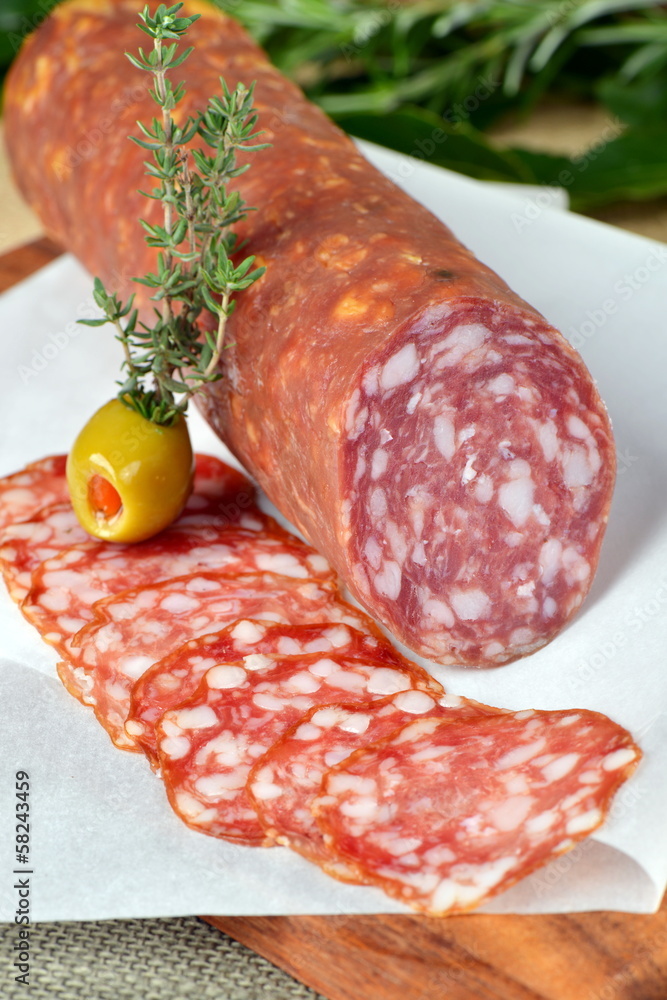 Salami sliced on wood background Salami sliced on wood background