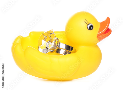 Fotografie Yellow rubber duck holding a diamond ring