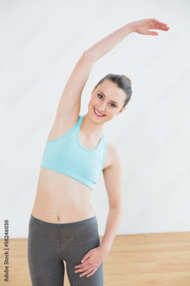 Sporty female stretching hand in fitness studio Sporty female stretching hand in fitness studio