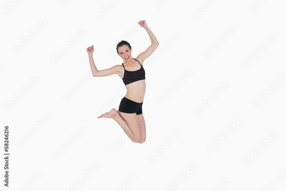 Full length of a sporty young woman jumping