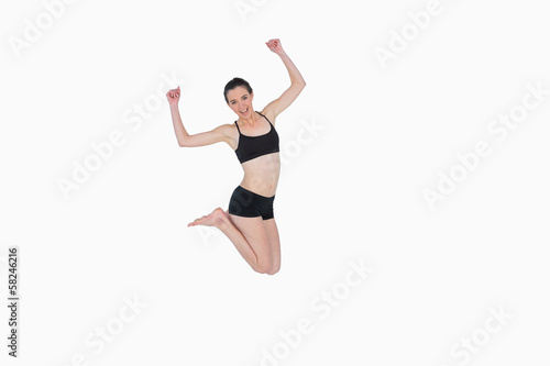 Full length of a sporty young woman jumping © lightwavemedia