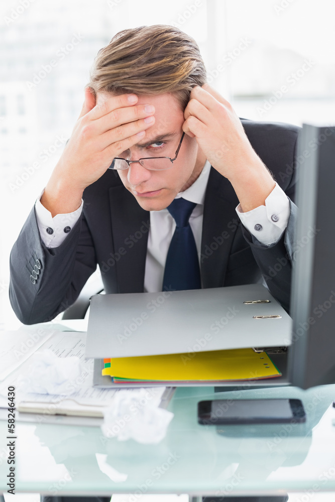 Worried businessman with documents at office desk Worried businessman with documents at office desk