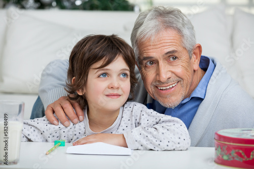 Boy And Grandfather With Envelope Smiling