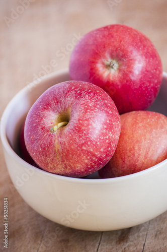 Fresh apples in a bowl over white
