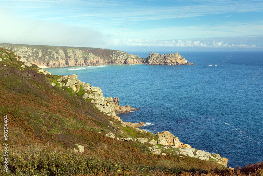 Coast of Cornwall England in autumn with mist and blue sky