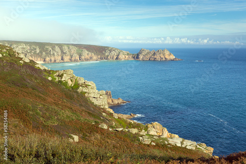 Coast of Cornwall England in autumn with mist and blue sky photo