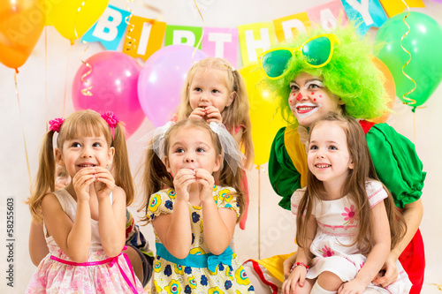 jolly children group and clown on birthday party