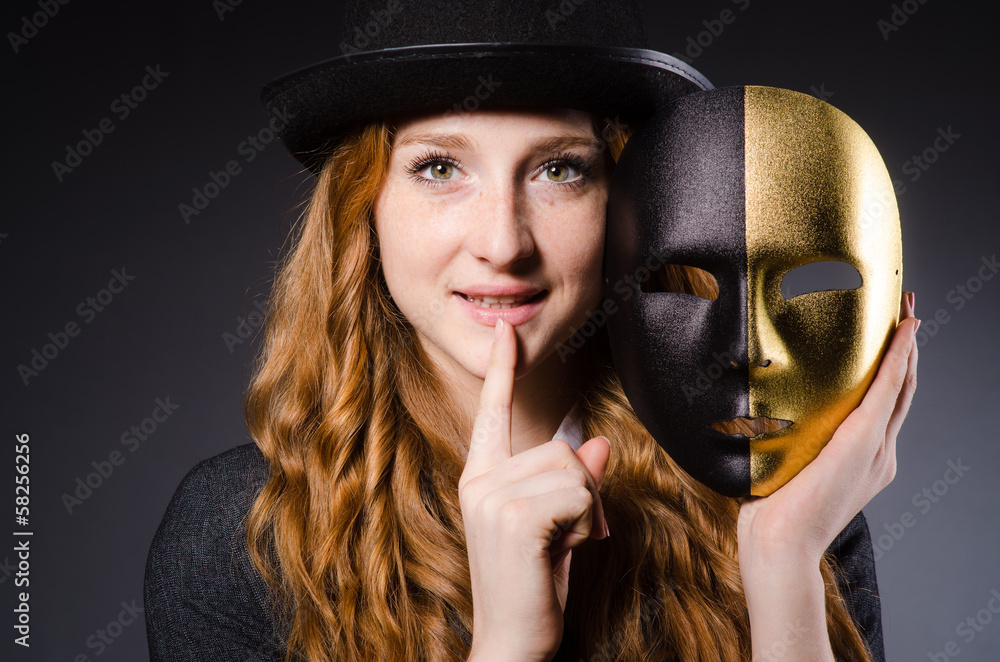 Woman with mask in hypocrisy concept Woman with mask in hypocrisy concept
