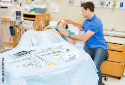 Operating Equipment On Table With Couple In Background At Hospit photo