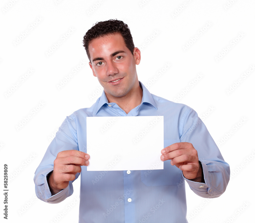 Young guy smiling and holding white card Young guy smiling and holding white card