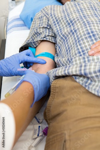 Doctor Drawing Blood From Patient's Arm © Tyler Olson