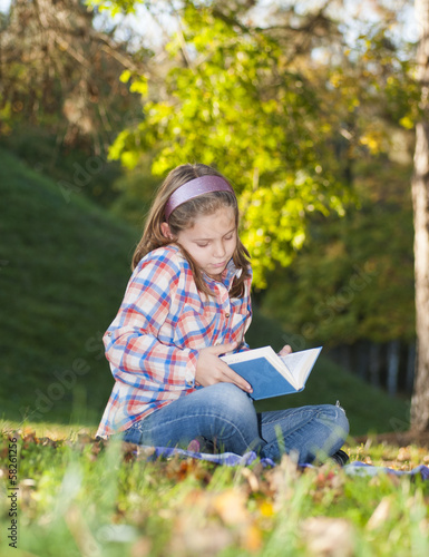 Girl with a book in the park