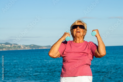 Senior woman shaping up on beach.