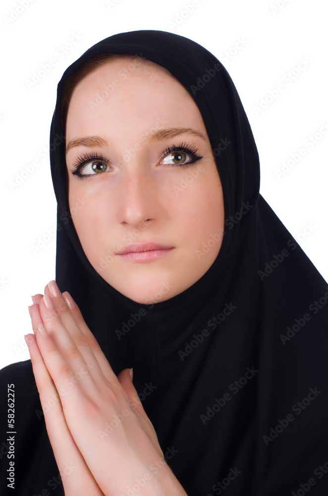 Young muslim woman praying isolated on white Young muslim woman praying isolated on white