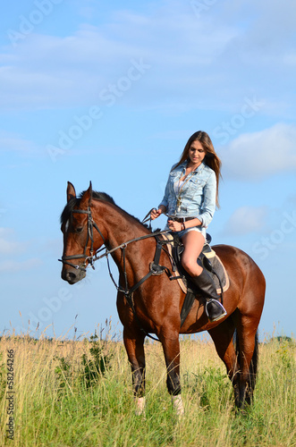 The woman on a horse in the field