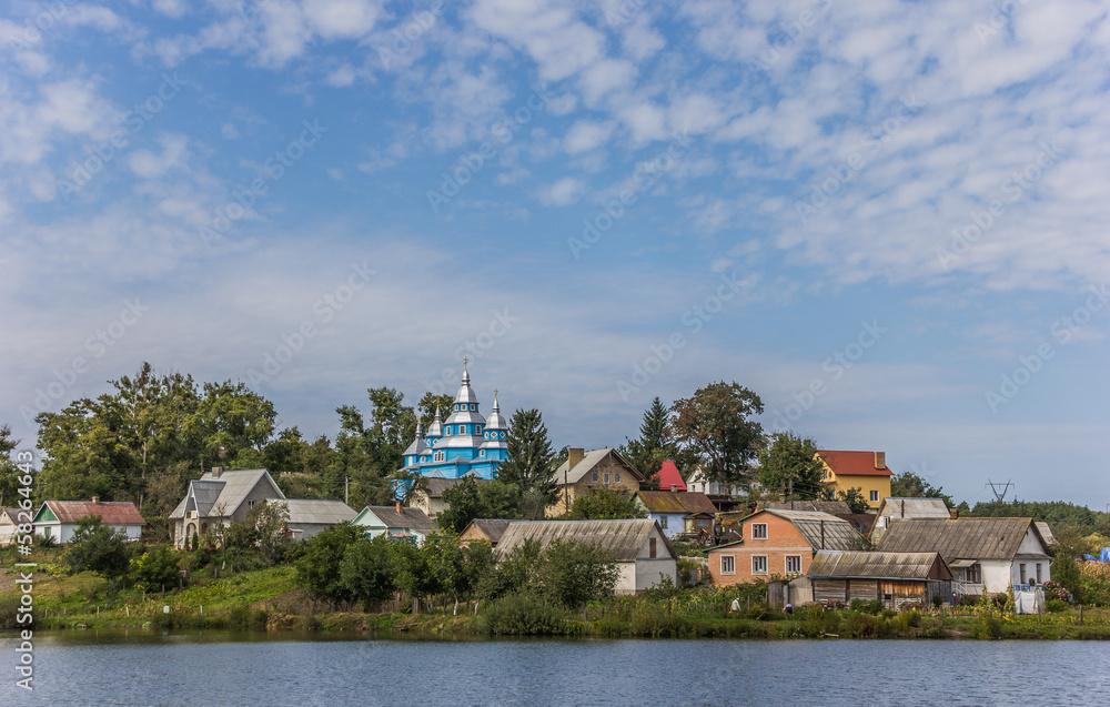 Obraz premium Small Ukrainian village with a blue church