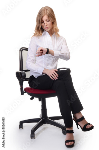 Businesswoman in an armchair isolated on white background