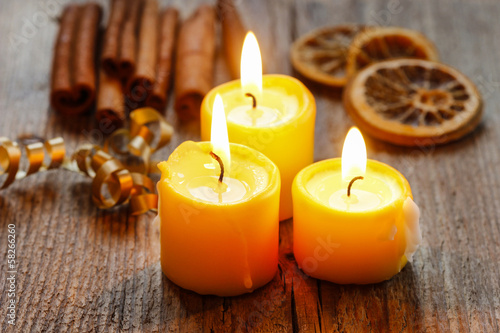 Beautiful golden candles on wooden table.