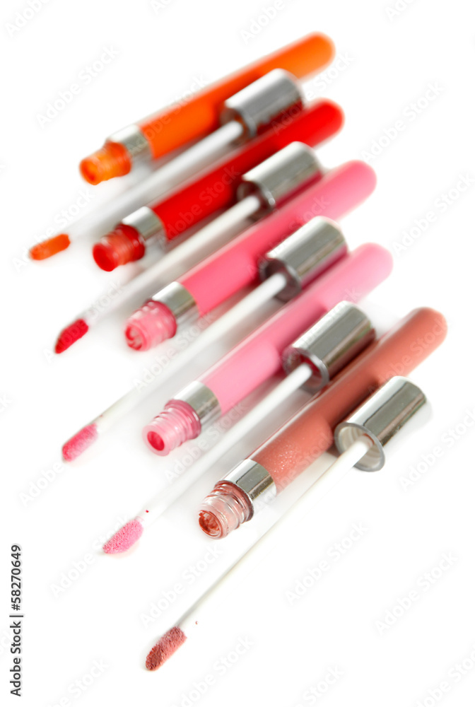 Beautiful lip glosses, isolated on white Beautiful lip glosses, isolated on white