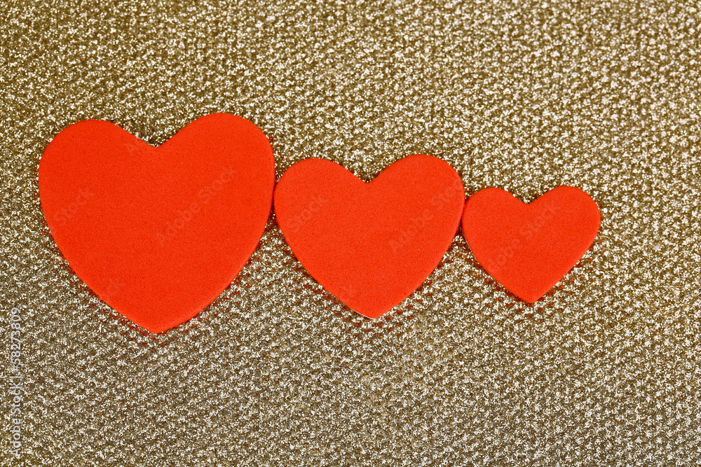 Hearts made of felt on golden background Hearts made of felt on golden background