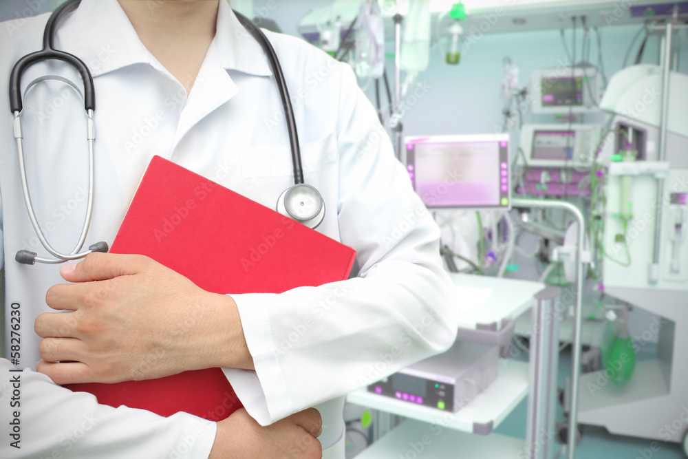 doctor with a book in the ICU. doctor with a book in the ICU.