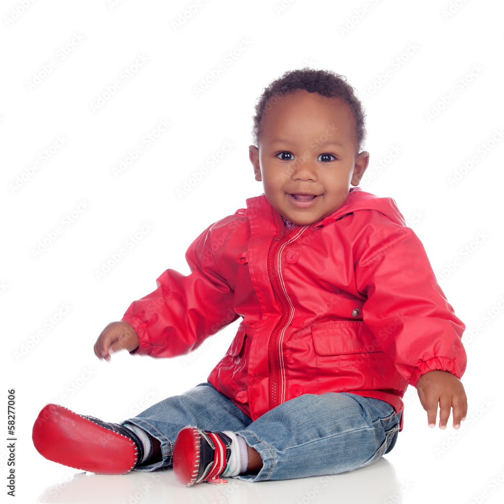 Adorable african baby sitting on the floor with red raincoat Adorable african baby sitting on the floor with red raincoat