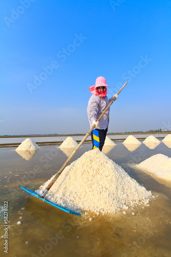 Woman working in the salt field in Thailand