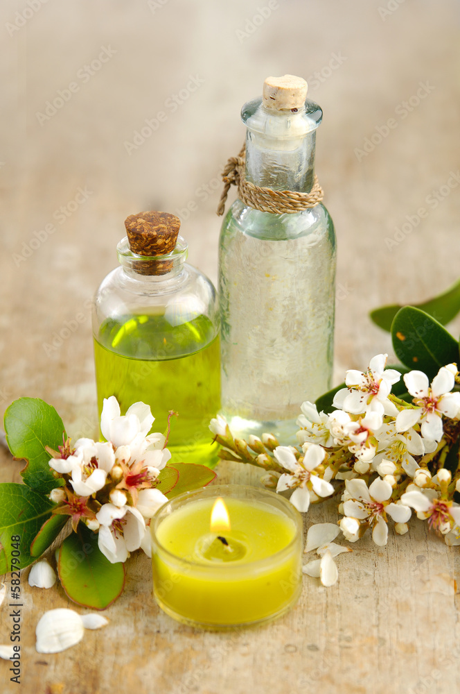 massage oil with and spring flower with candle on board massage oil with and spring flower with candle on board