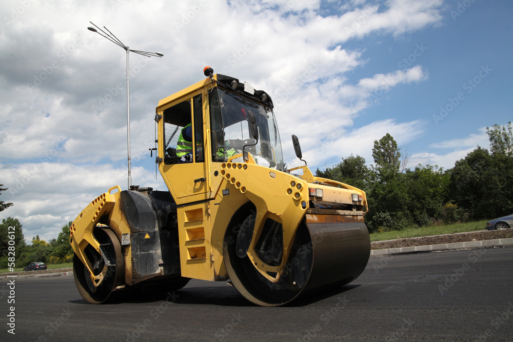 Fototapeta premium Large road-roller paving a road. Road construction