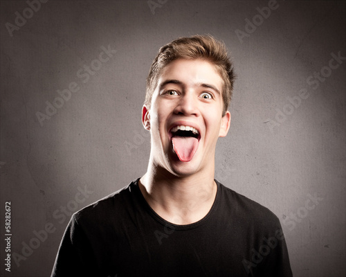 young man showing tongue