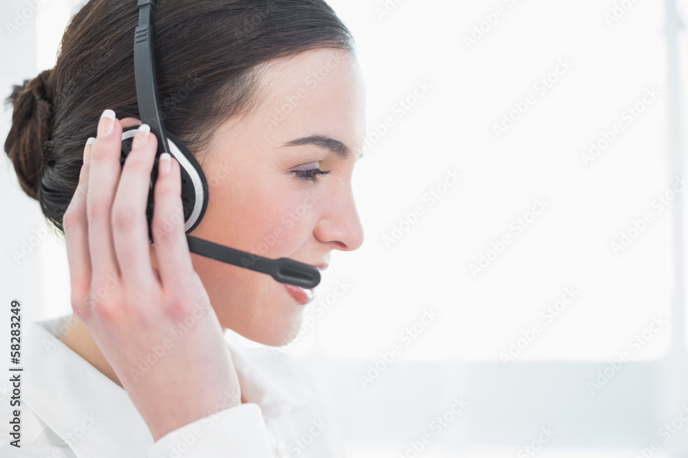 Close up side view of businesswoman wearing headset Close up side view of businesswoman wearing headset