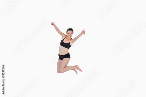 Full length of a sporty young woman jumping