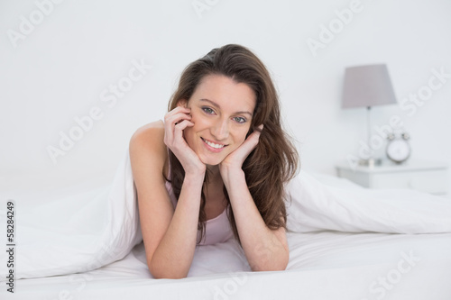 Close up portrait of a pretty woman resting in bed