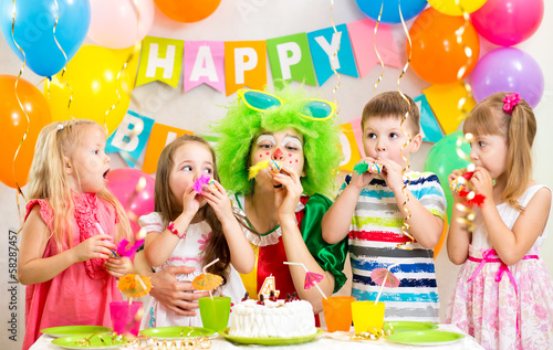 children and clown at birthday party