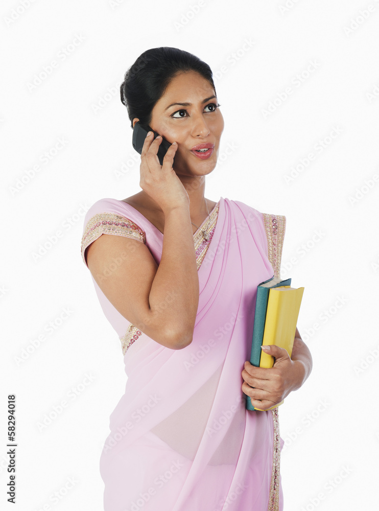 Woman talking on a mobile phone Woman talking on a mobile phone