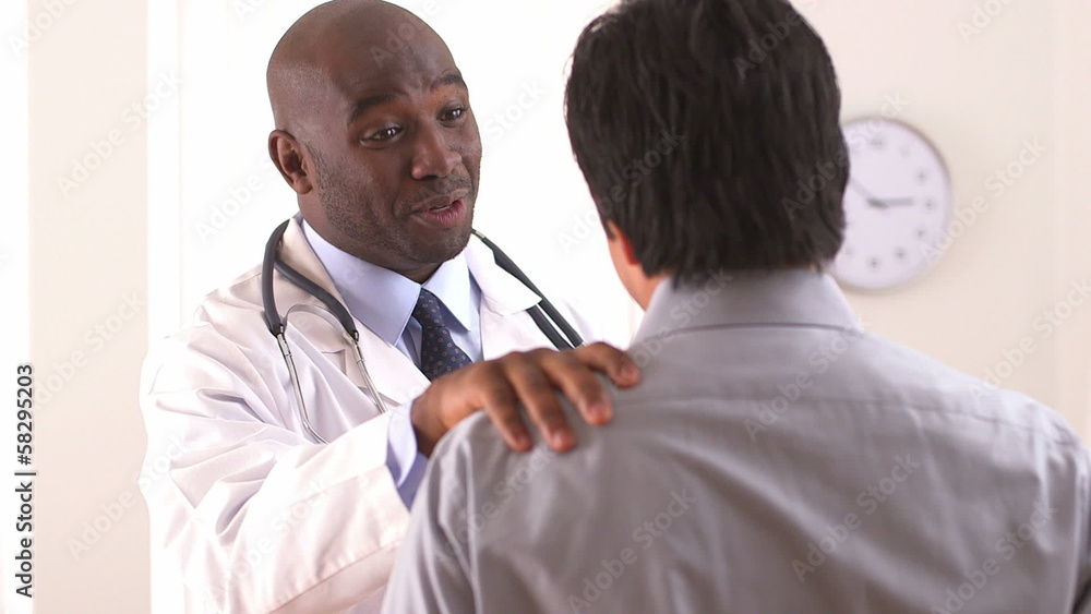 African American doctor talking to Hispanic patient